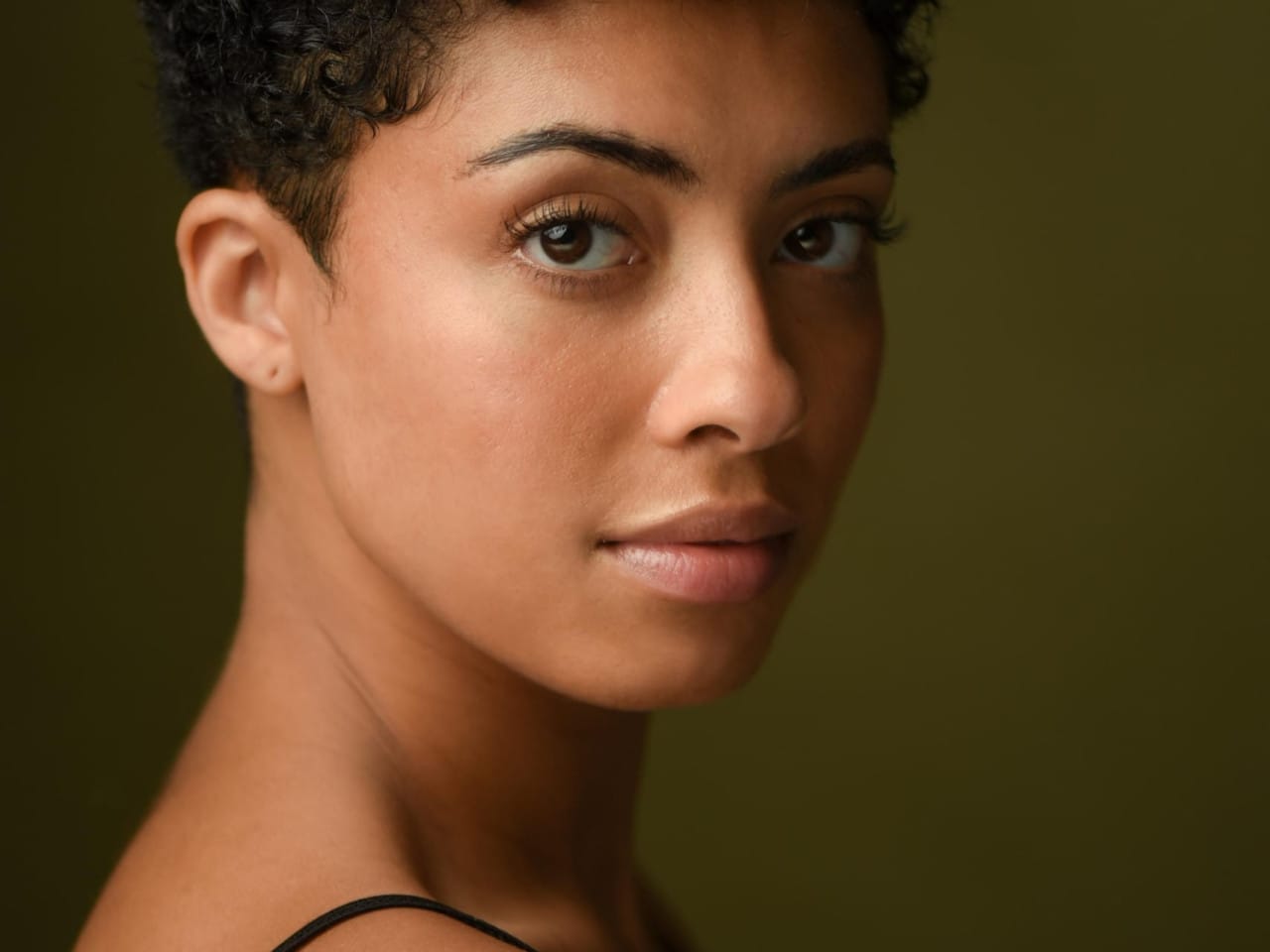 Performer’s headshot - low curly brown hair