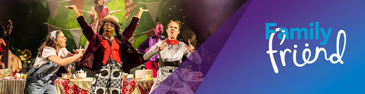 Colorful stage scene from a theatrical performance with three actors in costume mid-action in front of a table set for a whimsical tea party. The background has bunting and vibrant decor. Overlay text on the right reads “Family friend” in playful fonts against a blue and purple gradient.